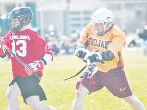 Michael Lavallee of the PCI Trojans lacrosse team hacks and opponent during a game May 9. (Kevin Hirschfield/THE GRAPHIC/QMI AGENCY)