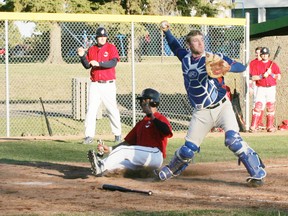 Stony Plain Mets catcher Tyler Lister begins to turn the back end of a 5-2-3 double play against the Edmonton Indians during the season-opening game for both teams last week. The Mets fell behind in this game 7-0 before rebounding to post a 9-8 victory. This twin killing was one of two the Mets turned in the game. - Gord Montgomery, Reporter/Examiner