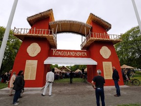 Guests attend the opening of the "Congo Village" in Oslo May 15, 2014. Displaying 80 people in a human zoo in Oslo's most elegant park, two artists hope their "Congo Village" display will help erase what they say is Norwegians' collective amnesia about racism. (REUTERS/Lise Aserud/NTB Scanpix)