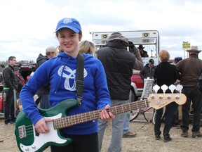 Elisa Brent, 11, made her first auction purchase for $175. She had her eye on the green base guitar and outbid some fierce competition. - Karen Haynes, Reporter/Examiner