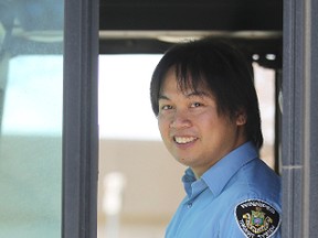 Winnipeg Transit driver Arnold Barayang is photographed on a bus in the Fort Rouge garage complex on Thu., May 15, 2014. Barayang has been lauded by drivers for his pleasant disposition, which includes holding a makeshift happy face sign out the window when a driver lets him into their lane. Kevin King/Winnipeg Sun/QMI Agency