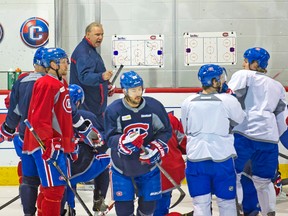Canadiens coach Michel Therrien appears to be losing his audience as he barks out instructions to a group of players during Friday’s practice at the Bell Centre. (Pierre-Paul Poulin, QMI Agency)