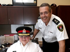 Kingston Police Chief for a day Ella Edwards with Kingston Police Chief Gilles Larochelle at Kingston Police headquarters on Friday. (Ian MacAlpine/The Whig-Standard)