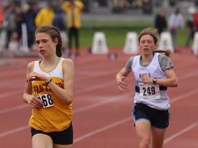 Branna MacDougall of Regiopolis-Notre Dame sets a new record of 9:53.80 on the way to winning the junior girls 3,000 metres race Friday at the KASSAA track and field meet at CaraCo Field. KC's Rachel Porter was second. (Elliot Ferguson/The Whig-Standard)