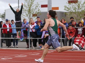 Darien Leblanc of Holy Cross runs to victory in the senior boys 100-metre race Friday at the KASSAA track and field meet at CaraCo Field. (Elliot Ferguson/The Whig-Standard)