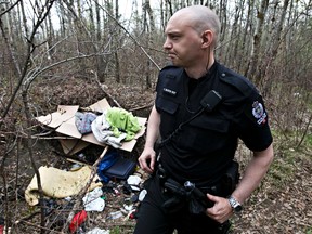 Const. Craig Beaton of the EPS Community Action Team (CAT) shows media a homeless camp found in Mill Creek Ravine on Friday. (David Bloom/Edmonton Sun)