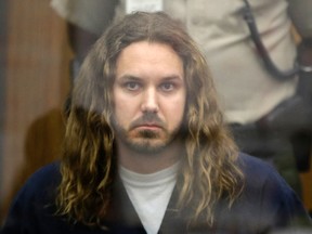 Tim Lambesis, lead singer for the heavy metal Christian band As I Lay Dying, looks on during his arraignment in San Diego North County court in Vista, California in this May 9, 2013 file photo.  REUTERS/Lenny Ignelzi/Pool/Files