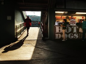 Workers prepare before the MLB American League baseball game between the Boston Red Sox and the Tampa Bay Rays at Fenway Park in Boston, Massachusetts in this September 8, 2010 file photograph. REUTERS/Brian Snyder/Files