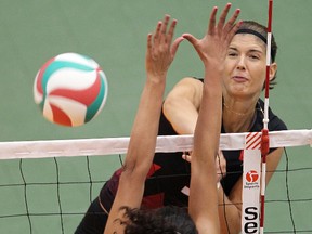 Canada's Tabi Love takes a swing against Peru's Karla Ortiz during exhibition volleyball in Winnipeg, Man. Tuesday August 20, 2013. (BRIAN DONOGH/WINNIPEG SUN/QMI AGENCY FILE)