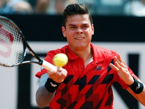 Milos Raonic of Canada returns the ball to Novak Djokovic of Serbia during their men's singles semifinal match at the Rome Masters tennis tournament May 17, 2014. (REUTERS/Stefano Rellandini)