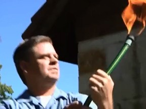 Video still of a man lighting a garden hose on fire.

(YouTube/HBO)