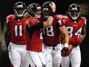 Atlanta Falcons tight end Tony Gonzalez (2nd R) celebrates a touchdown catch with quarterback Matt Ryan (2nd L), wide receiver Julio Jones (L) and wide receiver Roddy White (R) during the first half of their NFL football game against the New Orleans Saints in New Orleans, Louisiana September 8, 2013. (REUTERS)