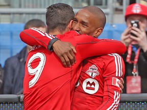 TFC’s Jermain Defoe (right) celebrates his goal with Gilberto during Saturday's game. (USA TODAY SPORTS)
