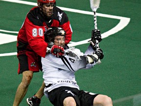 Edmonton's Mark Matthews is taken down by Calgary's Peter McFetridge during the second half of the Edmonton Rush's NLL lacrosse playoff game against the Calgary Roughnecks at Rexall Place in Edmonton, Alta., on Friday, May 16, 2014. Codie McLachlan/Edmonton Sun/QMI Agency