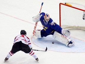 Canada's Ryan Ellis (L) scores past Sweden's goalie Anders Nilsson (R) during the extra time period of their men's ice hockey World Championship Group A game at Chizhovka Arena in Minsk May 18, 2014. (REUTERS/Vasily Fedosenko)