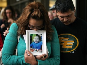 Sage Morin is comforted by a supporter as she holds a picture of her son Geo Mounsef outside the Law Courts on May 24, 2013. Geo, 2, was killed after an SUV plowed into the patio at Ric's Grill, 14229 - 23 Ave., where he was sitting with his family May 19, 2013. Richard Suter was granted bail in the incident Friday. David Bloom/Edmonton Sun/QMI Agency