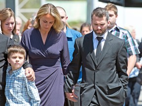 New York Rangers star Martin St. Louis walks with his family during the funeral on Sunday for his mother, France, at Laval, Que. The Rangers team, along with some current and past NHL stars, attended the funeral. (Joel Lemay, QMI Agency)