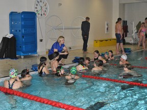 Blue Dolphins Head Coach Alice Boll gives a group of swimmers some instructions during a practice at the Allan & Jean Millar Centre on Wednesday, May 14.
Barry Kerton | Whitecourt Star