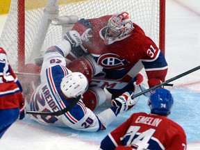 New York Rangers forward Chris Kreider (20) collides with Montreal Canadiens goalie Carey Price (31) during the second period in game one of the Eastern Conference Finals of the 2014 Stanley Cup Playoffs at the Bell Centre. (Eric Bolte-USA TODAY Sports)