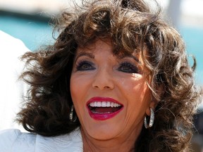 Cast member Joan Collins poses during a photocall on the Majectic beach to promote the film "The Time of Their Lives" at the 67th Cannes Film Festival in Cannes May 18, 2014. (REUTERS/Yves Herman)