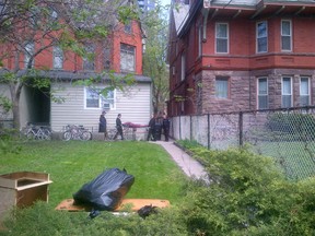 A woman's body is removed from a roominghouse on Isabella St. in Toronto Monday, May 19, 2014. (Kevin Connor/Toronto Sun)