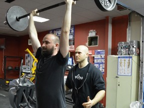 Brickhouse Gym was voted Winnipeg's best gym in a Your Winnipeg poll. Owner Paul Taylor and client Dirk Hoeppner show how it's done. (TESSA VANDERHART/Winnipeg Sun)