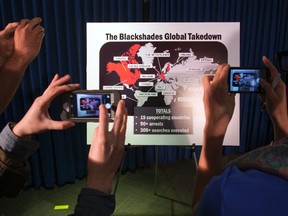 Journalists take photographs of a display referring to BlackShades malware during a news conference by the U.S. Attorney for the Southern District of New York to announce law enforcement action to target creators and purveyors of malicious computer software, in Lower Manhattan, New York May 19, 2014.  REUTERS/Adrees Latif