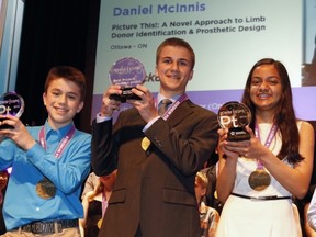 Riverside South's Daniel McInnis, centre, won Best Project at a national science fair in Windsor on May 15, 2014. He's flanked by fellow platinum winners Thomas Imbeault-Nepton (Best Junior) of Saguenay-Lac Saint-Jean, Que., and Maya Burhanpurkar (Best Intermediate) of Simcoe County, Ont. (Canada-Wide Science Fair image)