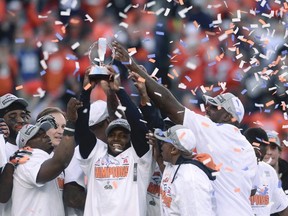Broncos players hold up the Lamar Hunt Trophy after they defeated the Patriots in the AFC Championship in Denver on Jan. 19, 2014. (Mark Leffingwell/Reuters/Files)