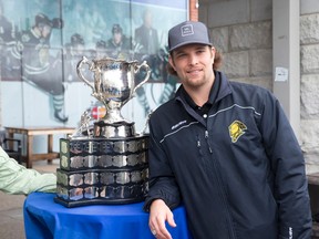 Former London Knights player Rob Schremp poses with the Memorial Cup after it was paraded through London, Ont., on Thursday, May 15, 2014. Schremp lost his Memorial Cup ring last week and is hoping the public can help find it. (Craig Glover/QMI Agency)