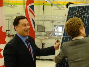 In January 2011, Ontario's then- energy minister, MPP Brad Duguid smiles as his then- cabinet
colleague, and now Premier Kathleen Wynne signs a solar panel at Celestica Inc. in Don Mills.
Antonella Artuso/Toronto Sun Files