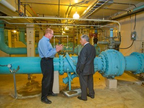 Dan Huggins, a city water quality manager, explains to Mayor Joe Fontana how the facility?s six pumps feed London with Lake Huron water during a visit to the Arva pumping station Tuesday. (Mike Hensen, The London Free Press)