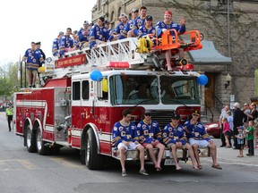 Members of the Carleton Place Canadians ride a fire truck Tuesday during a parade to celebrate their second-place finish at the RBC Cup national junior A hockey championship. (CHRIS HOFLEY/Ottawa Sun)