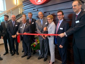 Ontario Premier Kathleen Wynne cuts the ribbon with August Oetker to officially open the Dr. Oetker pizza plant on Tuesday May 20, 2014 (MORRIS LAMONT, The London Free Press)