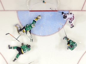 Guelph Storm forward Kerby Rychel, right, tucks the puck into the corner of the net as Val d'Or Foreurs goaltender Antoine Bibeau dives across in an attempt to save the puck during their 2014 Memorial Cup round robin hockey game at Budweiser Gardens in London, Ontario on Monday May 19, 2014. (CRAIG GLOVER, The London Free Press)