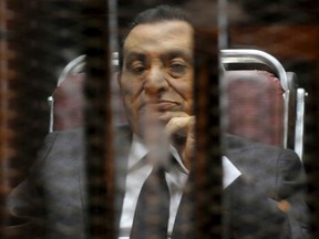 Egypt's ousted President Hosni Mubarak looks on as he reacts inside a dock at the police academy on the outskirts of Cairo May 21, 2014. An Egyptian court on Wednesday sentenced Hosni Mubarak to three years in prison on charges of stealing public funds. (REUTERS/Stringer)