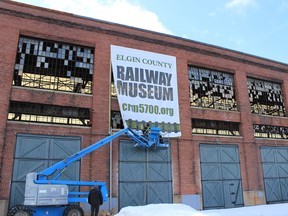 The first of what will be a wall of banners is installed on the side of Elgin County Railway Museum earlier this year. The museum celebrates the centenary of construction of the historic locomotive repair shops where it is located, this weekend.

Dawn Miskelly/Elgin County Railway Museum