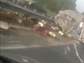 Boxes of bee hives were scattered on a Newark, Del., highway after a transport truck carrying the hives crashed. (Facebook/Miguel Pena screengrab)