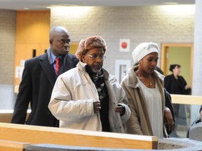 Moussa Sidime, centre, is pictured at the Longueuil, Que., courthouse in this Feb. 11, 2014 file photo. (JEAN LARAMÉE/QMI AGENCY)