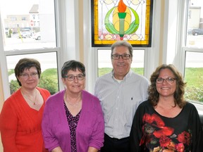 Ken Ahrens (second from right) recently donated to the West Perth Public Library and their staff this stained glass work of art, which hangs on the building’s north window of the lower level. Sherri Bennewies (left), Caroline Shewburg and Deanna Schoustra (right) accepted the donation last week. Staff members Jane McKenzie and Eleanor Lutes were absent. ANDY BADER/MITCHELL ADVOCATE