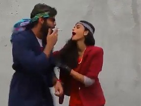 A man and a woman are seen lip-syching to Pharrell Williams' "Happy" in this screengrab of a video uploaded to YouTube. (YouTube)