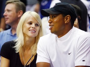 Tiger Woods and Elin Nordegren watch Game 4 of the NBA Finals in Orlando in this June 11, 2009, file photo. (REUTERS/Hans Deryk/Files)