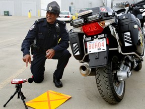 Edmonton Police Service Constable Vincent Pillay shows the equipment used to test noise level on motorcycles.  Weather permitting there will be excessive noise level testing clinic held at NAIT south campus parking lot at 7110 Gateway Boulevard on Saturday, May 24, 2014, from 10 a.m. to 6 p.m. This is a public education event, there will be no noise bylaw tickets handed out at this event. Tom Braid/Edmonton Sun/QMI Agency
