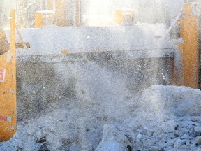 An Edmonton snow removal crew uses a giant snow blower to remove windrows along 188 street at 73 avenue in Edmonton, Alta., on Wednesday Feb. 5,  2014. Tom Braid/Edmonton Sun