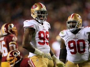 Outside linebacker Aldon Smith (left) and Glenn Dorsey of the San Francisco 49ers celebrate a sack during NFL action against the Washington Redskins at FedExField on November 25. (Rob Carr/Getty Images/AFP)