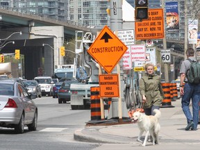 Signage and pylons litter the sides of Lake Shore Blvd. W., which is to be closed intermittently for repairs, on Wednesday, May 21, 2014. (Stan Behal/Toronto Sun)