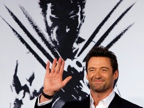 Actor Hugh Jackman waves to fans as he attends the Japan premiere of his movie "The Wolverine" in Tokyo August 28, 2013. The movie will be screened in Japan on September 13. 
REUTERS/Yuya Shino