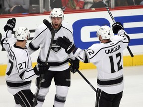 Los Angeles Kings defenceman Jake Muzzin (middle) celebrates with teammates Marian Gaborik (12) and Alec Martinez after scoring against the Chicago Blackhawks during Game 2of the Western Conference final at United Center. (Jerry Lai/USA TODAY Sports)