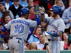 Toronto Blue Jays first baseman Edwin Encarnacion (10) celebrates his home run against the Boston Red Sox with third baseman Brett Lawrie during the second inning Wednesday at Fenway Park. (Mark L. Baer/USA TODAY Sports)