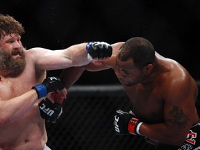 Daniel Cormier (red gloves) fights Roy Nelson in their heavyweight bout during UFC 166 at Toyota Center. (Andrew Richardson/USA TODAY Sports)